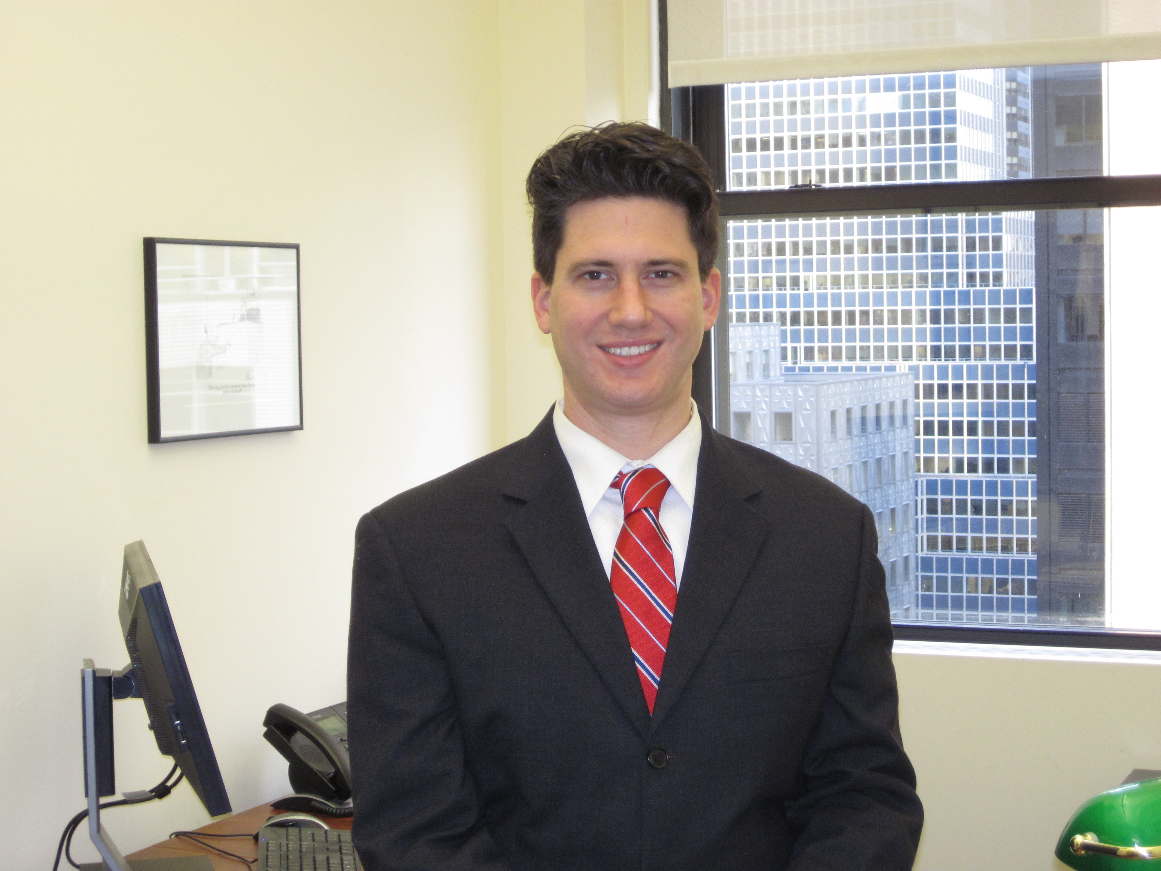 Smiling businessman wearing suit and red tie